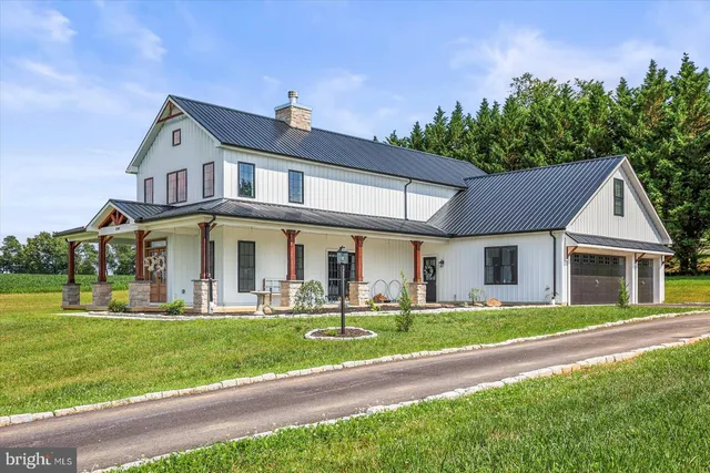 a front view of a house with a yard table and chairs