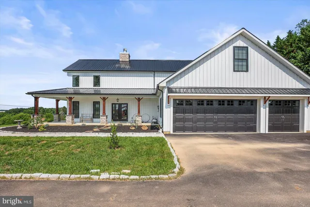 a front view of a house with outdoor seating
