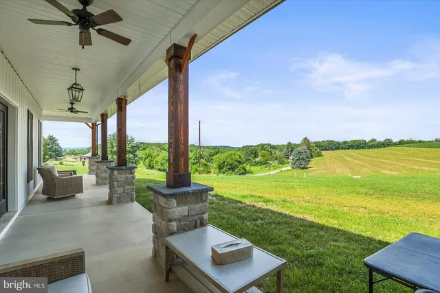 a patio with water view and a big yard