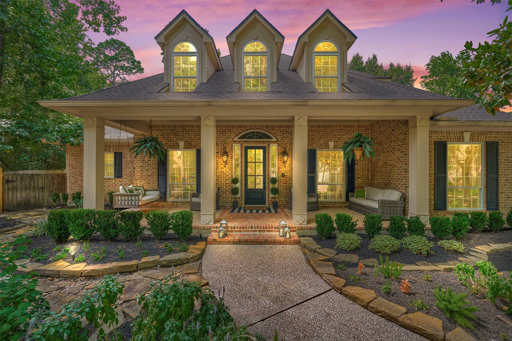18 Treevine Court The Woodlands, TX 77381 - Photo 3 of 50 Well-manicured landscaping leads to the charming, sprawling covered front porch.