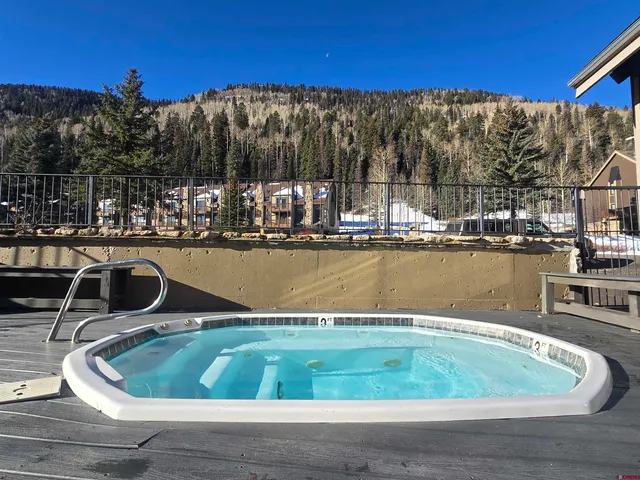 a view of a swimming pool with a table and chairs
