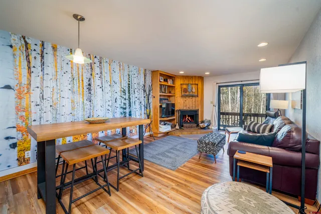 a living room with furniture a rug and a chandelier