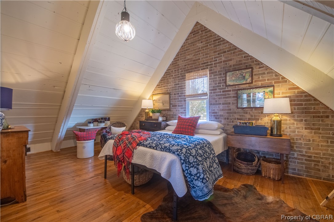 2515 Red Bank Road Gloucester, VA 23061 - Photo 42 of 49 Bedroom featuring high vaulted ceiling, light hardwood / wood-style flooring, beam ceiling, and brick wall