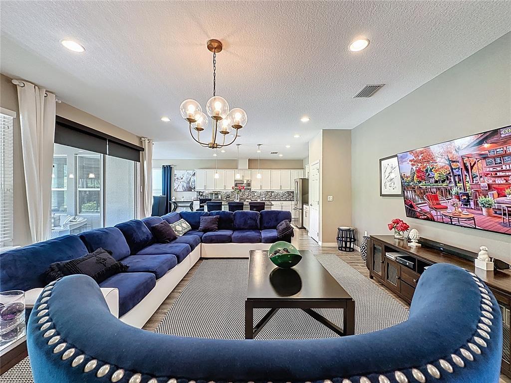 201 Silver Maple Road Groveland, FL 34736 - Photo 11 of 89 a living room with furniture and a flat screen tv