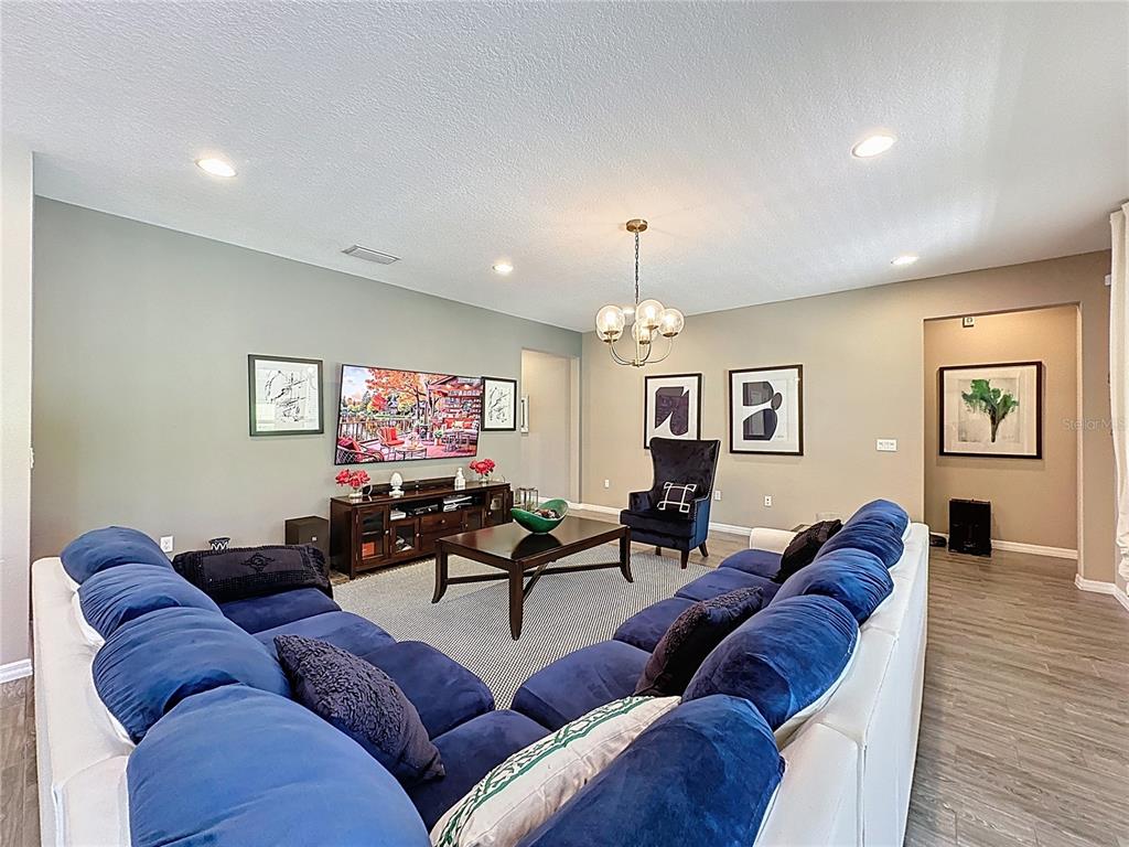 201 Silver Maple Road Groveland, FL 34736 - Photo 13 of 89 a living room with furniture ceiling fan and a wooden floor