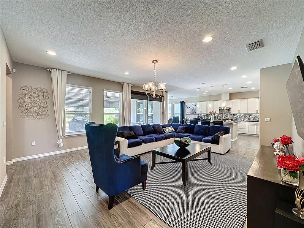 201 Silver Maple Road Groveland, FL 34736 - Photo 16 of 89 a living room with furniture and wooden floor