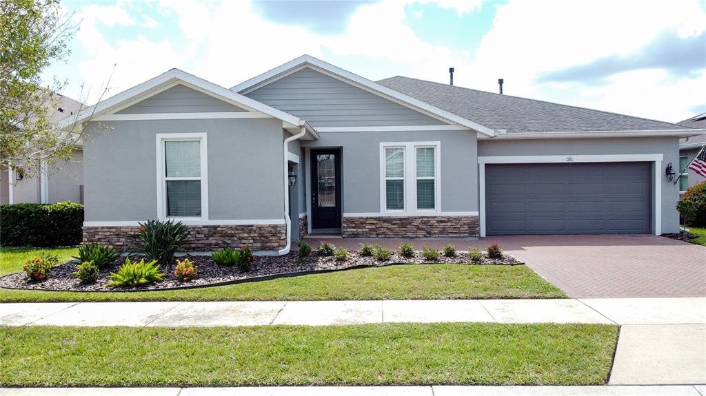 201 Silver Maple Road Groveland, FL 34736 - Photo 3 of 89 a front view of a house with a yard