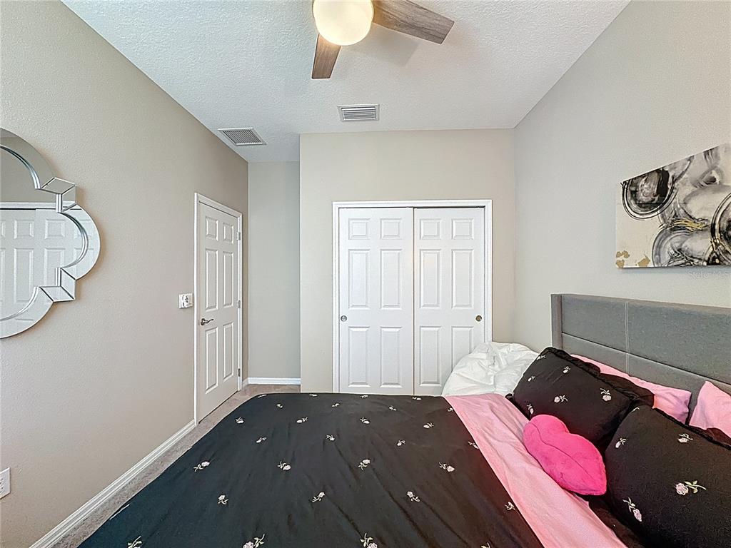 201 Silver Maple Road Groveland, FL 34736 - Photo 32 of 89 a bedroom with a bed and wooden floor