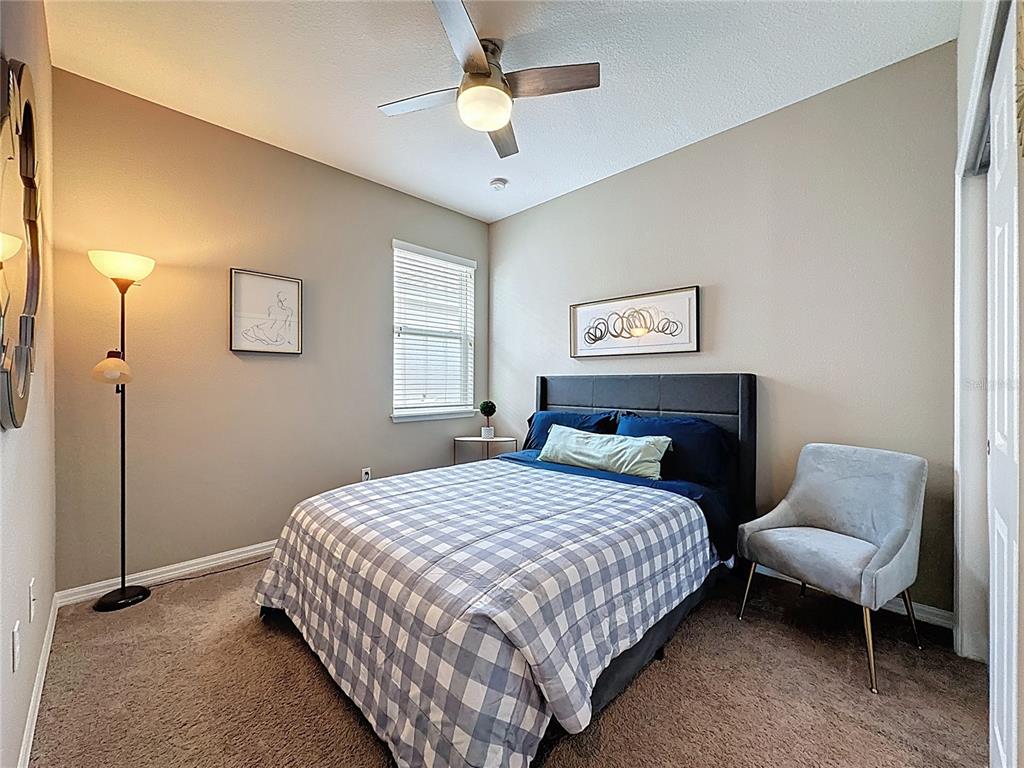 201 Silver Maple Road Groveland, FL 34736 - Photo 36 of 89 a bedroom with a bed and a couch