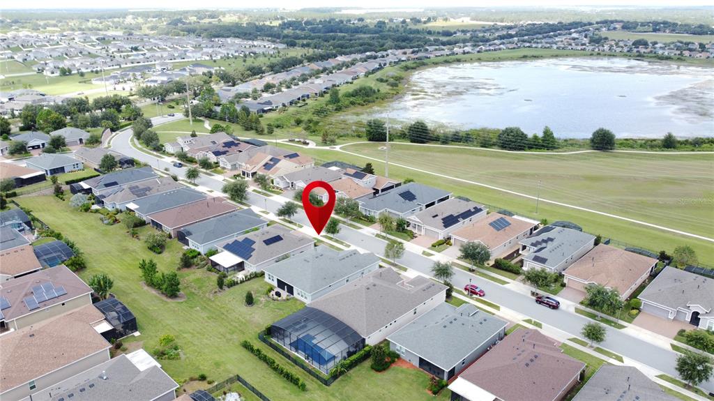 201 Silver Maple Road Groveland, FL 34736 - Photo 68 of 89 an aerial view of a city with lots of residential buildings ocean and mountain view in back