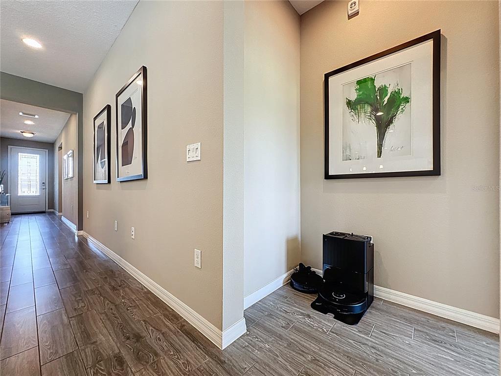 201 Silver Maple Road Groveland, FL 34736 - Photo 8 of 89 a view of a hallway with wooden floor and a workspace