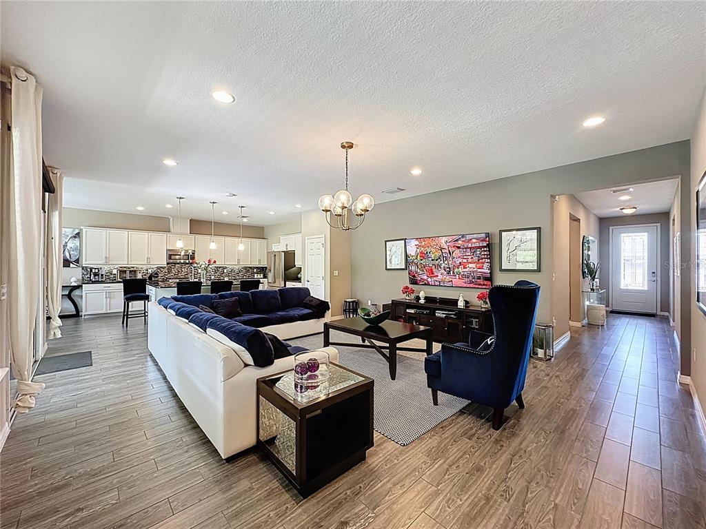 201 Silver Maple Road Groveland, FL 34736 - Photo 9 of 89 a living room with furniture and wooden floor