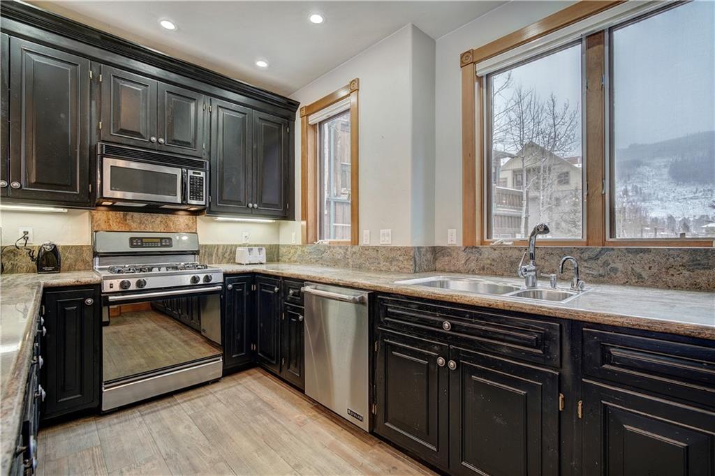 72 River Run Road Keystone, CO 80435 - Photo 14 of 35 a kitchen with stainless steel appliances granite countertop a stove a sink and a microwave