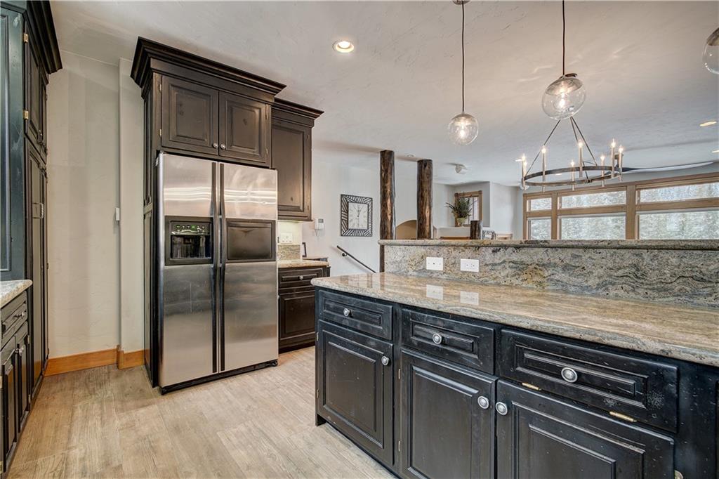 72 River Run Road Keystone, CO 80435 - Photo 16 of 35 a kitchen with stainless steel appliances granite countertop a refrigerator a sink and a stove