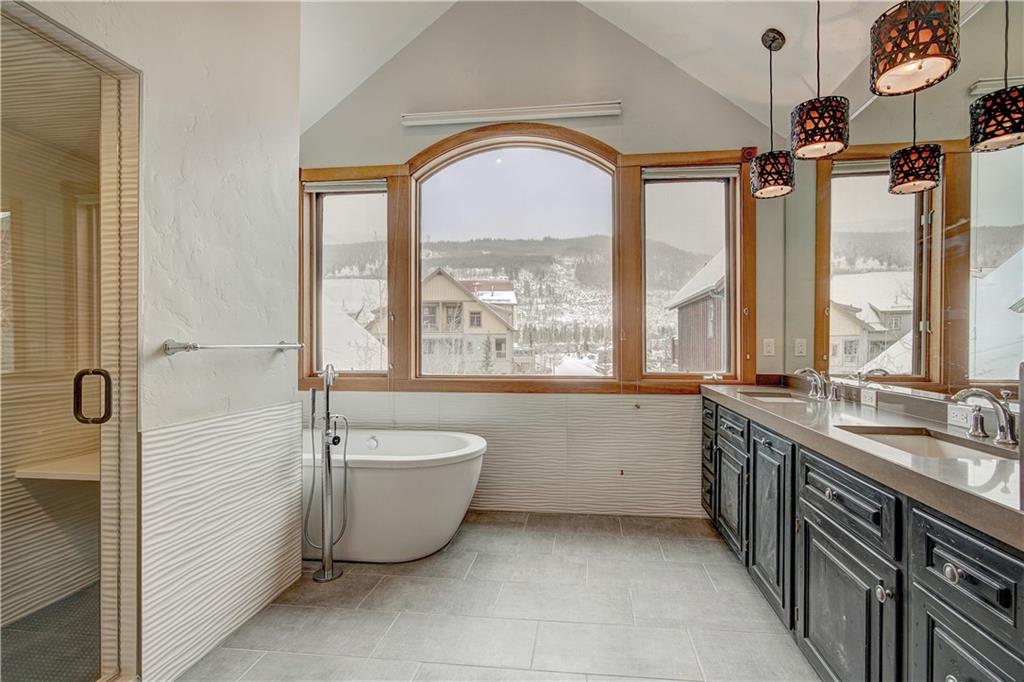 72 River Run Road Keystone, CO 80435 - Photo 17 of 35 a spacious bathroom with a tub sink and mirror