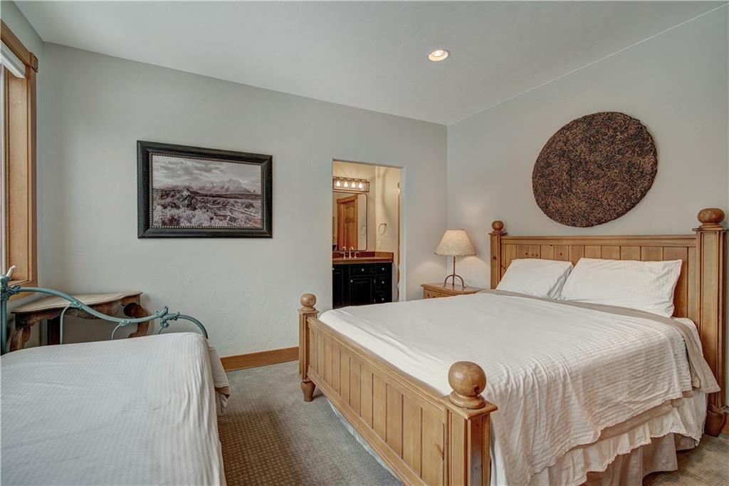 72 River Run Road Keystone, CO 80435 - Photo 18 of 35 a bedroom with a bed and a large mirror on the dresser