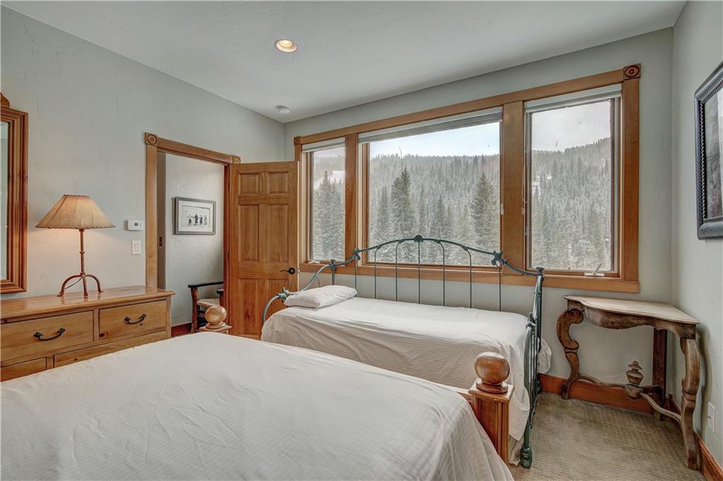 72 River Run Road Keystone, CO 80435 - Photo 20 of 35 a bedroom with a bed and large windows