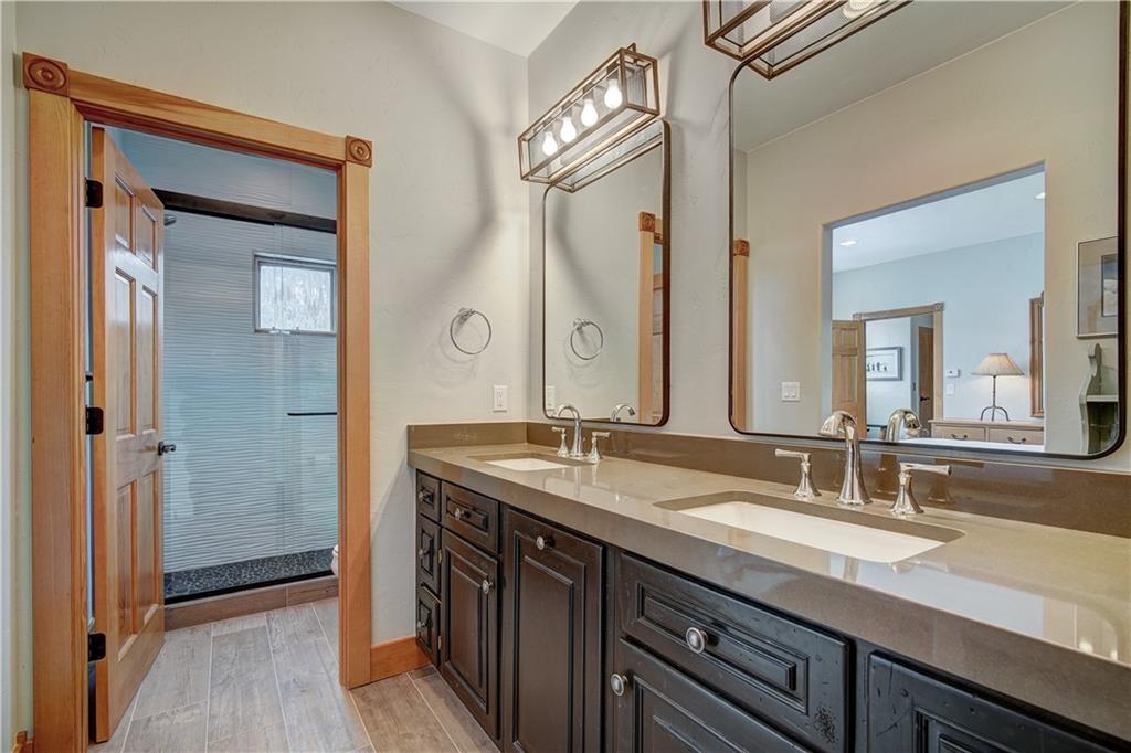 72 River Run Road Keystone, CO 80435 - Photo 21 of 35 a bathroom with a granite countertop sink double and shower