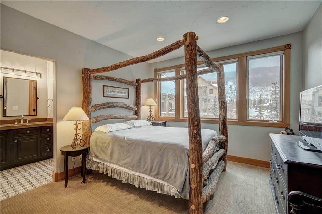 72 River Run Road Keystone, CO 80435 - Photo 22 of 35 a bedroom with a bed chair and a large window