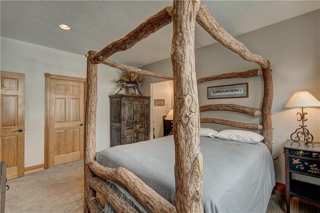 72 River Run Road Keystone, CO 80435 - Photo 23 of 35 a bed room with a bed and a chair