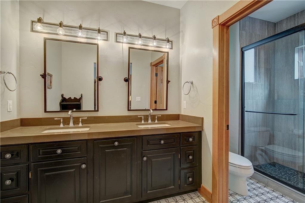 72 River Run Road Keystone, CO 80435 - Photo 25 of 35 a bathroom with a granite countertop sink toilet and shower