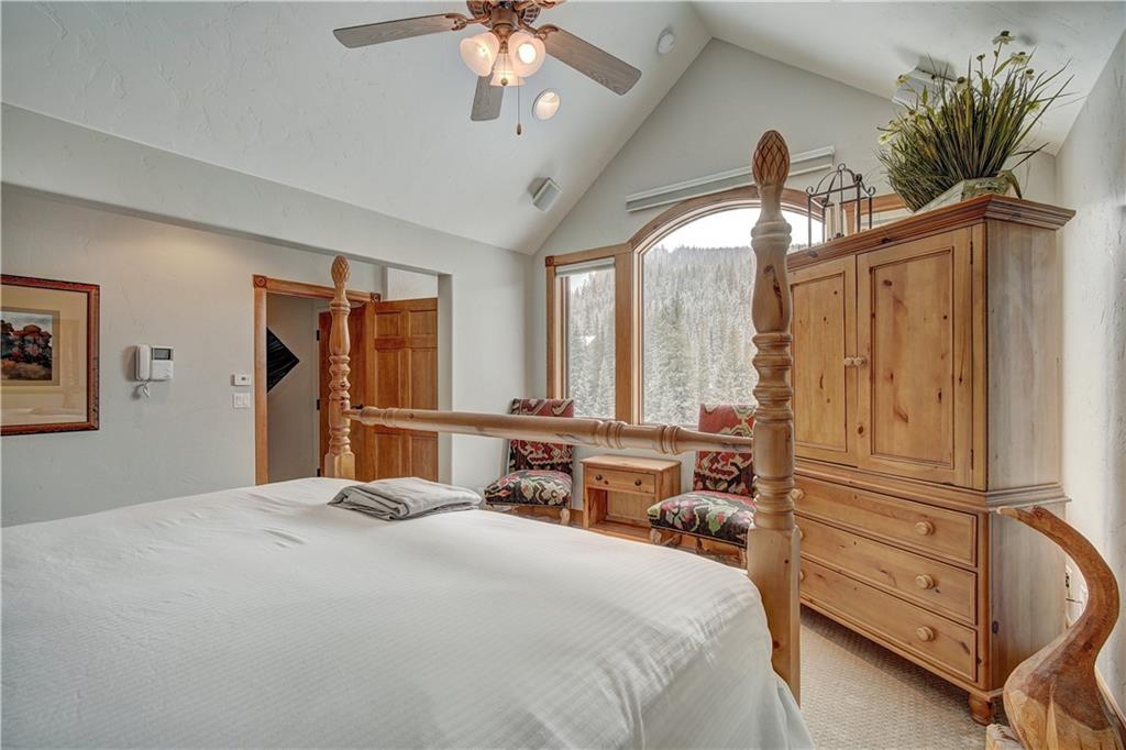 72 River Run Road Keystone, CO 80435 - Photo 28 of 35 a bedroom with a large bed and furniture