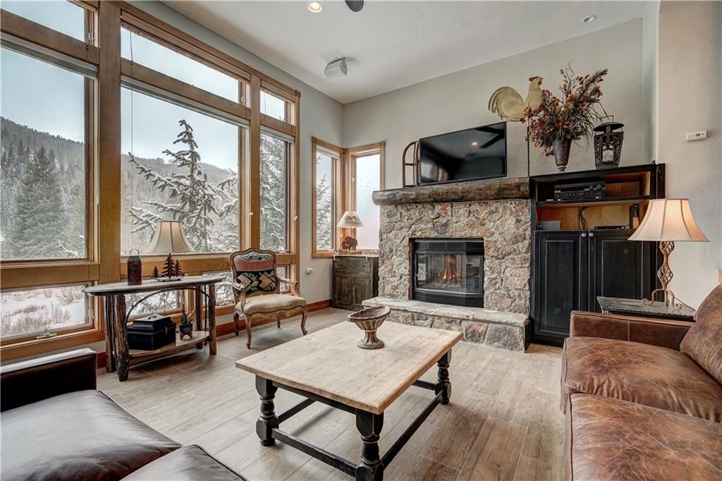 72 River Run Road Keystone, CO 80435 - Photo 5 of 35 a living room with furniture a window and a fireplace