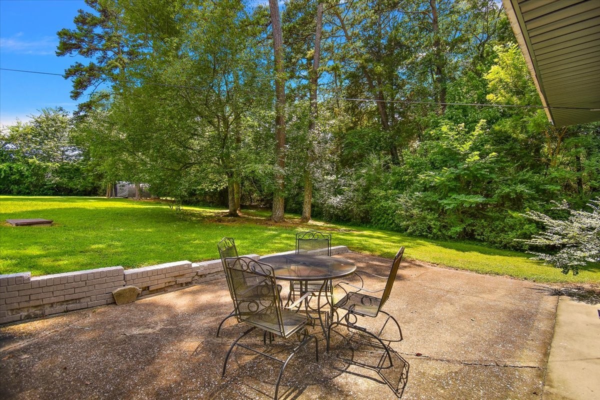 19 Horseshoe Bend Road Leoma, TN 38468 - Photo 24 of 29 a view of a swimming pool with a table and chairs under an umbrella