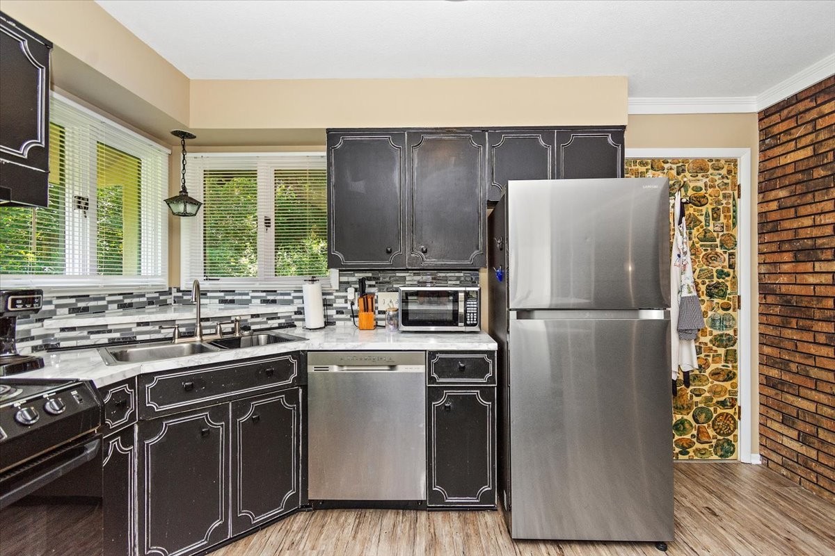 19 Horseshoe Bend Road Leoma, TN 38468 - Photo 8 of 29 a kitchen with stainless steel appliances a refrigerator a stove a sink and a cabinets