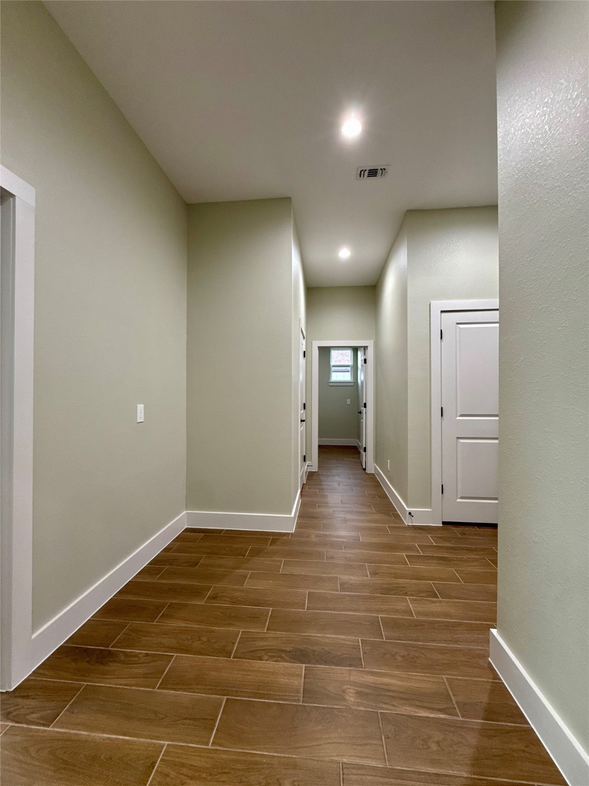 925 Buffalo Trail Angleton, TX 77515 - Photo 16 of 19 a view of a hallway with wooden floor