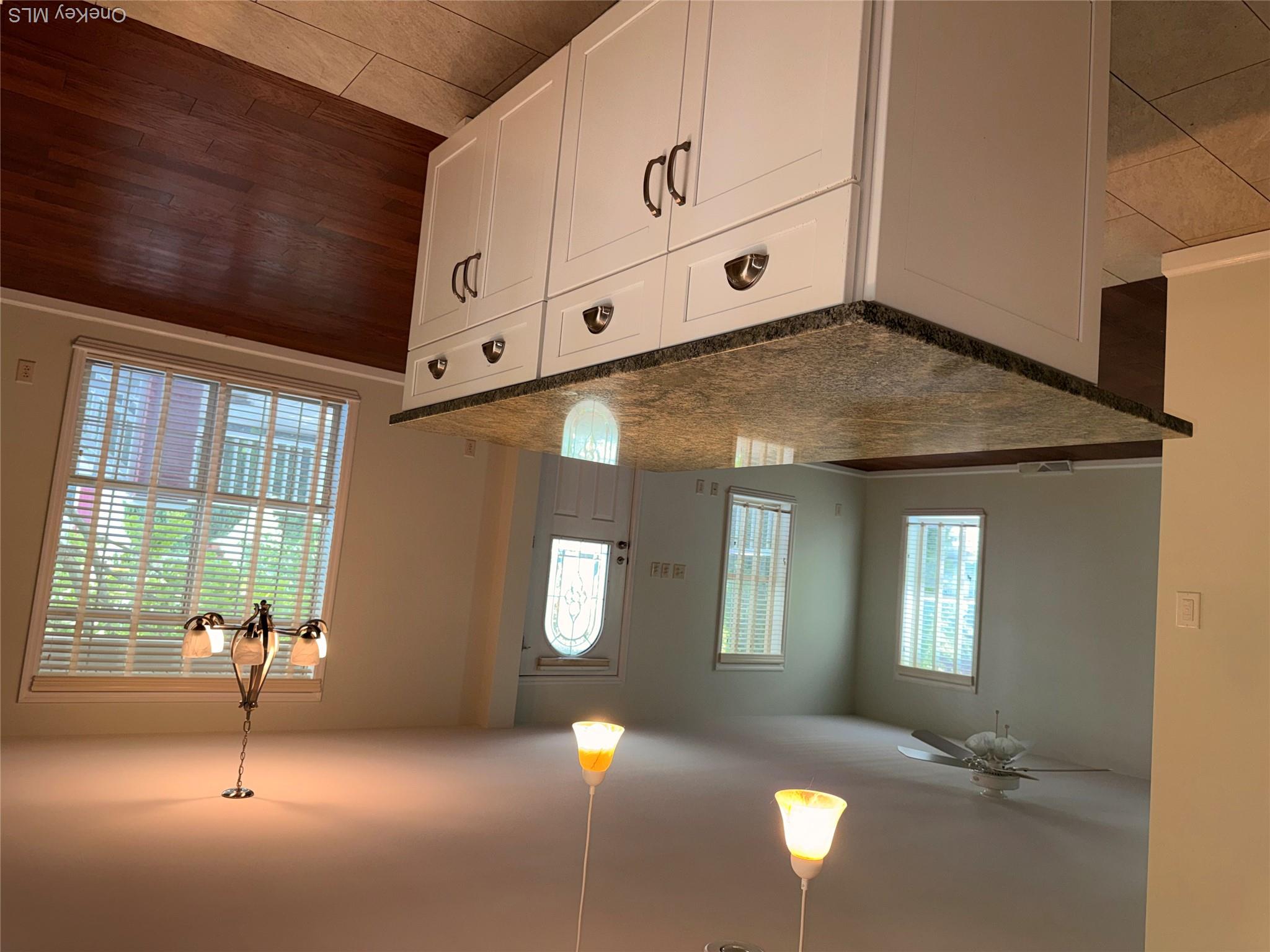 1661 Old Country Road, Unit 516 Riverhead, NY 11901 - Photo 19 of 50 an open kitchen with sink and mirror