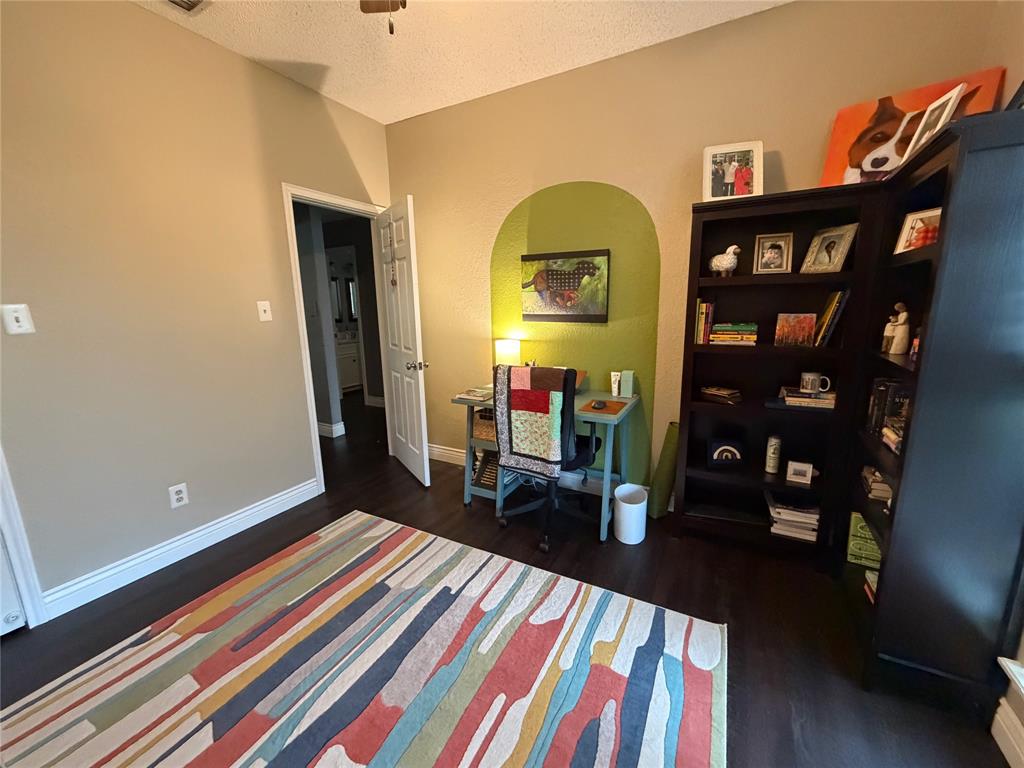 925 Manciples Way Abilene, TX 79602 - Photo 12 of 30 a living room with furniture a rug and book shelf