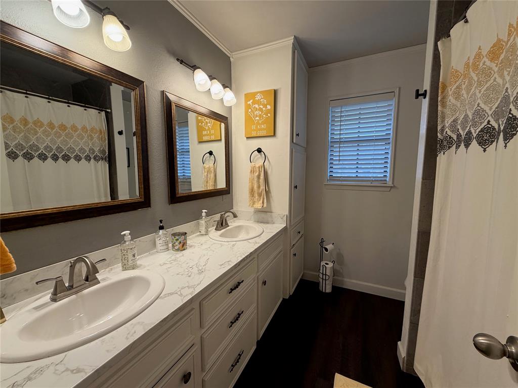 925 Manciples Way Abilene, TX 79602 - Photo 13 of 30 a bathroom with a double vanity sink and a mirror