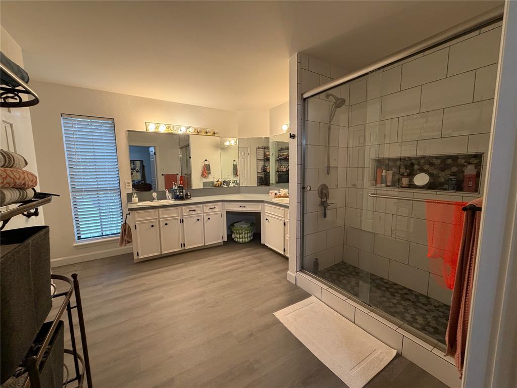 925 Manciples Way Abilene, TX 79602 - Photo 24 of 30 a bathroom with a sink a mirror and a shower