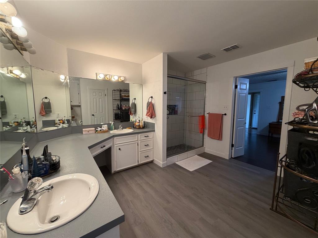 925 Manciples Way Abilene, TX 79602 - Photo 25 of 30 a kitchen with a sink dishwasher a stove and a refrigerator with wooden floor