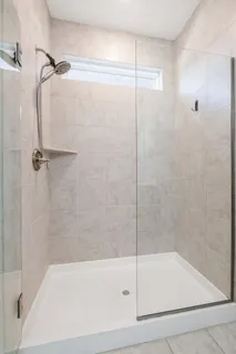 a bathroom with a shower and a bath tub