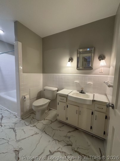 1513 Raeford Road Fayetteville, NC 28305 - Photo 16 of 25 a spacious bathroom with a toilet sink and mirror
