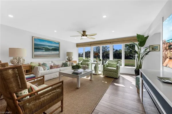 a living room with furniture and large windows