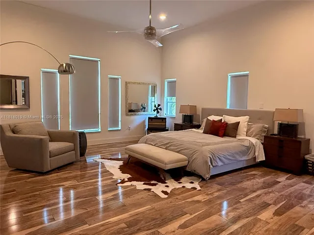 a spacious bedroom with a bed a couch and a dresser