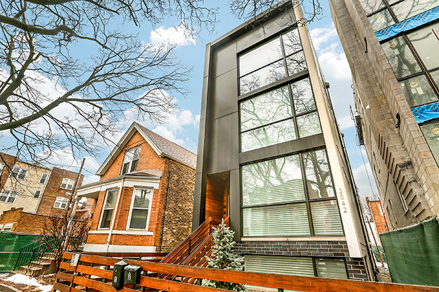 2042 West Rice Street, Unit 1 Chicago, IL 60622 - Photo 1 of 27 a front view of a residential apartment building with a yard