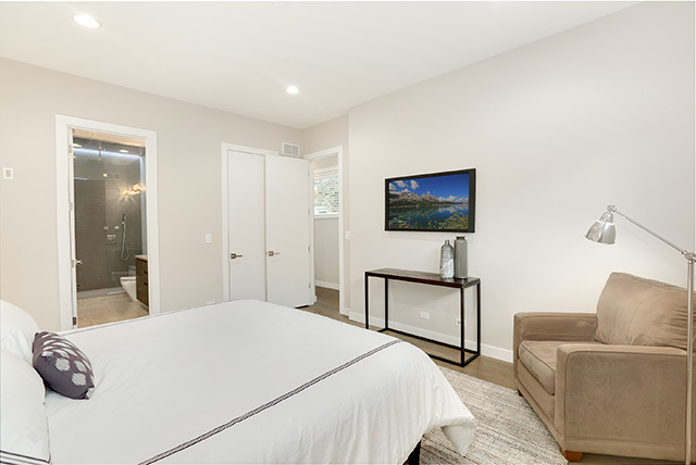 2042 West Rice Street, Unit 1 Chicago, IL 60622 - Photo 14 of 27 a bedroom with a bed and a television