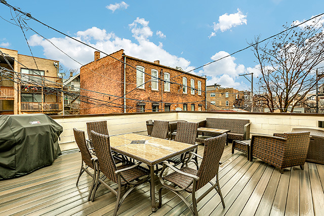 2042 West Rice Street, Unit 1 Chicago, IL 60622 - Photo 26 of 27 a roof deck view with table and chairs