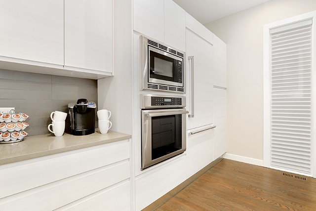 2042 West Rice Street, Unit 1 Chicago, IL 60622 - Photo 9 of 27 a kitchen with granite countertop a stove and a wooden floor
