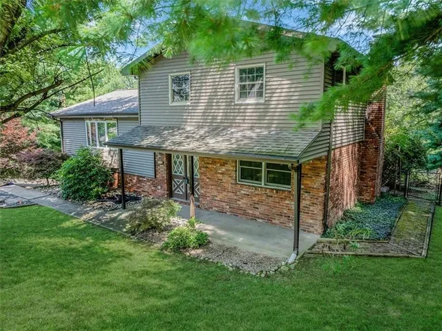a front view of a house with a garden