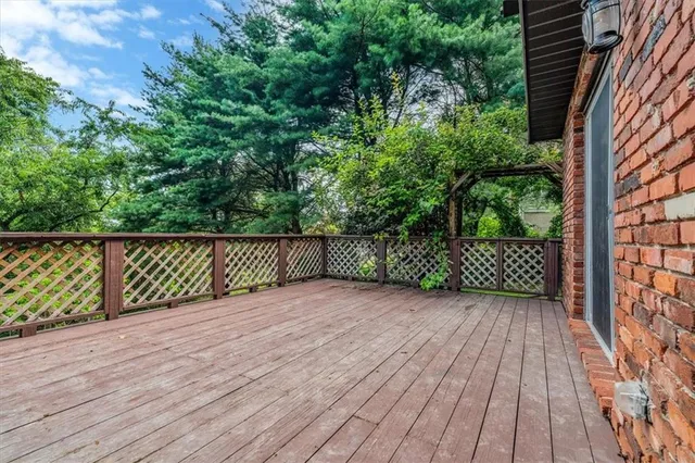 a view of a wooden fence and trees