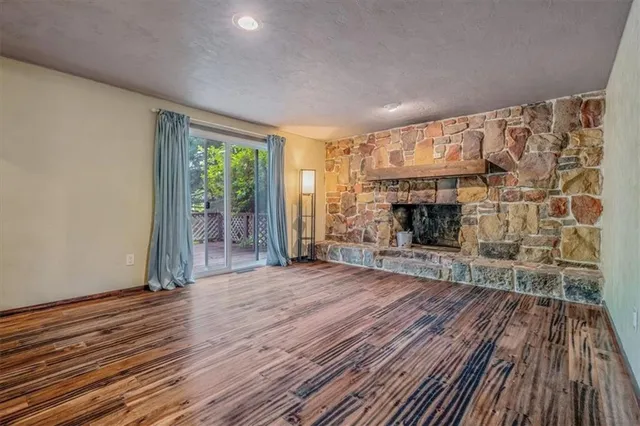 wooden floor fireplace and natural light in room