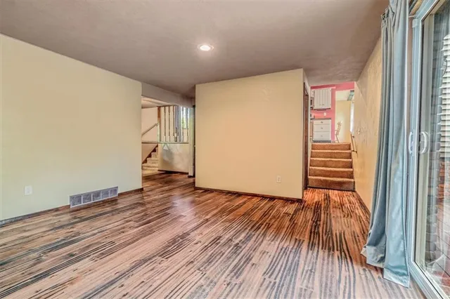 a view of a room with wooden floor and stairs