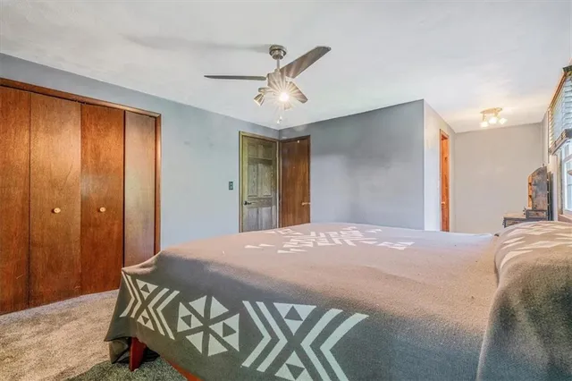 a bedroom with a bed and a large mirror