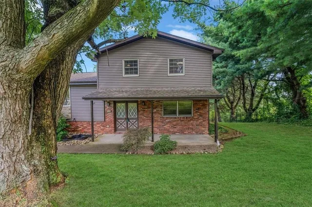 a backyard of a house with table and chairs