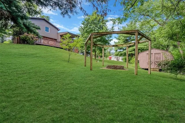 a view of a garden with a house in the background